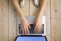 Image of womanÃ¢â¬â¢s hands typing fast on laptop keyboard with dogÃ¢â¬â¢s paws on same tabletop. View from above. Remote work from home